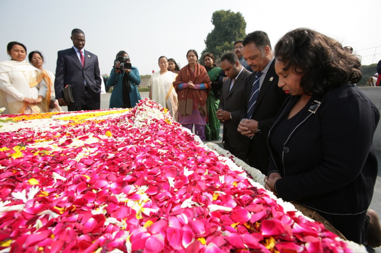 (On far right) Mrs. Jacqueline Jackson, her husband the Rev. Jesse Jackson, and son, Jonathan, pray at the grave of Mohandas K " Mahatma" Gandhi's tomb  in New Delhi.