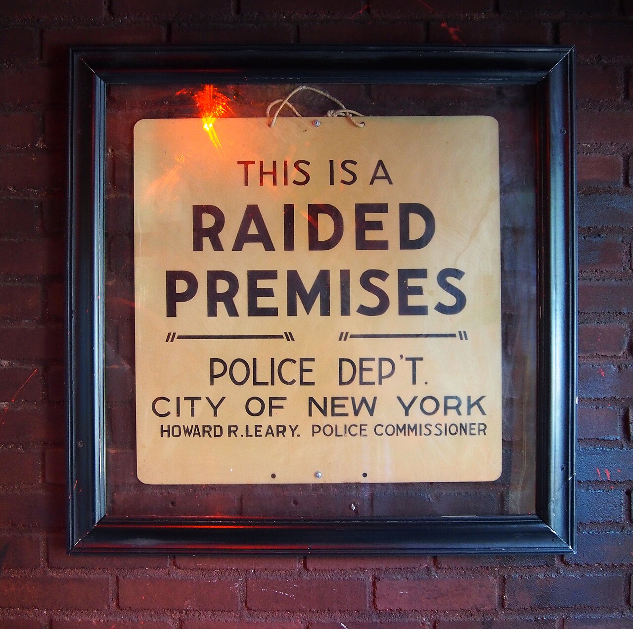 The "raided premises" sign just inside the door at the Stonewall Inn, a gay bar on Christopher Street in Manhattan's Greenwich Village. A 1969 police raid here led to the Stonewall riots, one of the m