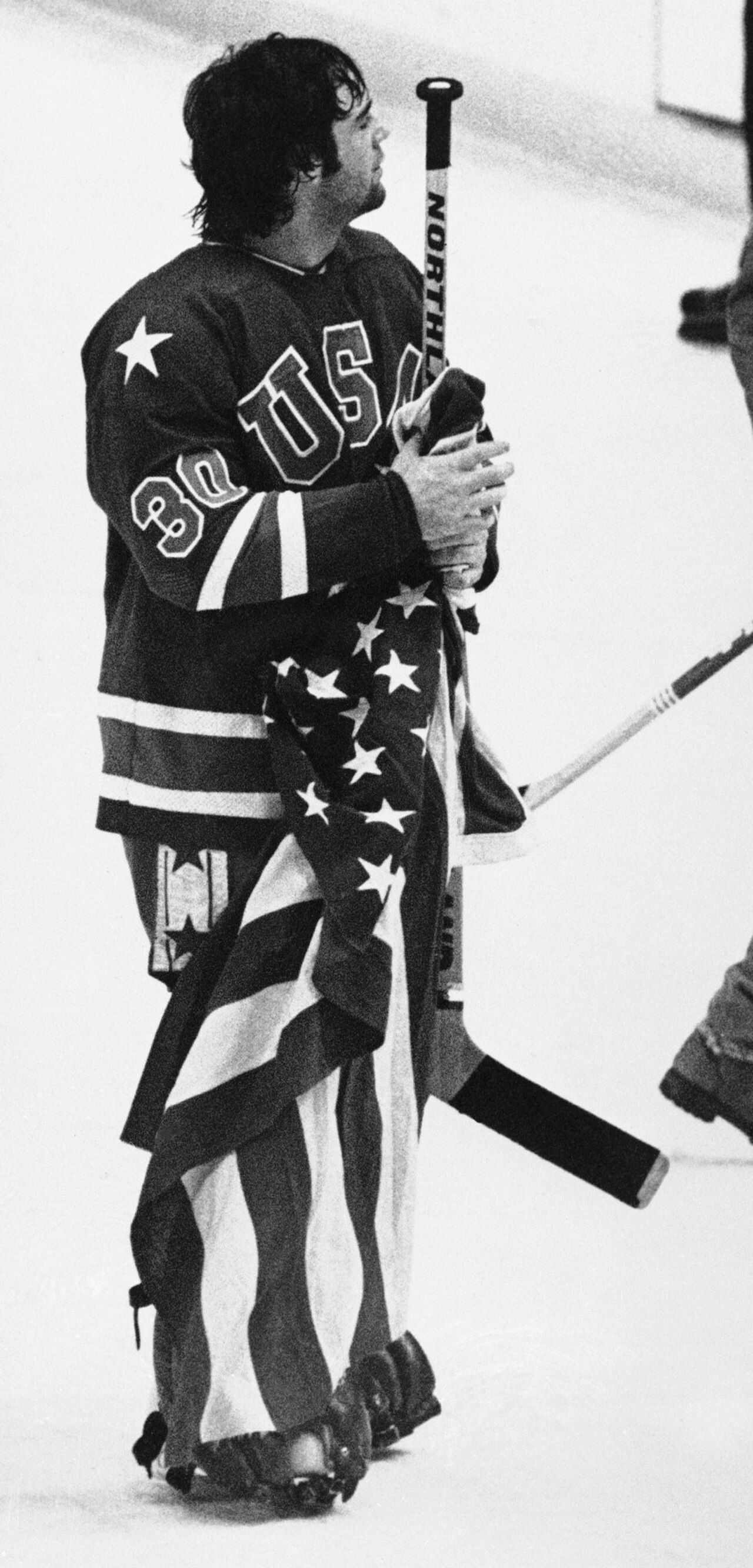 Goalie Jim Craig of the United States men's national ice hockey team clutches the American flag after his team won the gold medal at the 1980 Winter Olympics, defeating Finland by a score of 4-2.


Th
